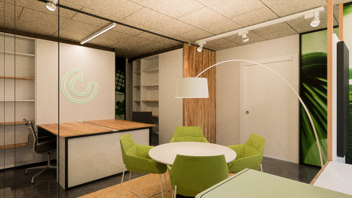 Oficina con puestos de trabajo y mesa de reunión verde